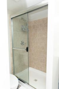a glass shower stall with a toilet in a bathroom at Juliet's Cozy Retreat in Worcester +24 photos
