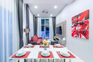 a living room with a table and a red chair at The Garnet Light Pool Villa Aonang-3BR Private Pool Villa in Ao Nang Beach