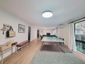 a living room with a ping pong table in it at Buckley s 10 in Point Lonsdale