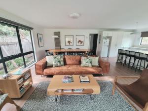a living room with a couch and a table at Buckley s 10 in Point Lonsdale