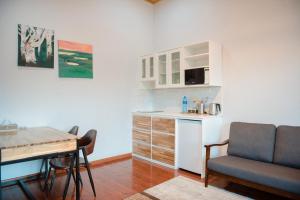 a kitchen with a desk and a table and a chair at Red Rock Resort Mongolia in Yoliin Hural