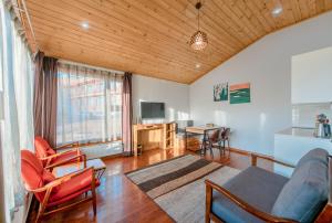 a living room with a couch and a table at Red Rock Resort Mongolia in Yoliin Hural