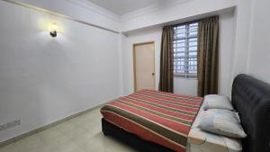 a hotel room with a bed and a window at Centrum Homstay at Crown Imperial Court in Cameron Highlands