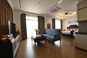 a living room with a blue chair and a couch at Nhật Long Hotel in Giap Ninh Binh