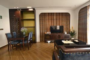 a living room with a television and a table and chairs at Nhật Long Hotel in Giap Ninh Binh +20 photos