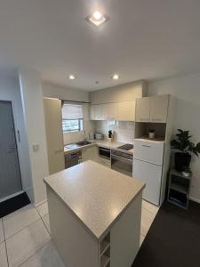 a large kitchen with a island in the middle at Wānaka Edge Retreat in Wanaka