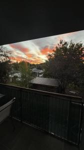 a view of a sunset from a balcony at Wānaka Edge Retreat in Wanaka