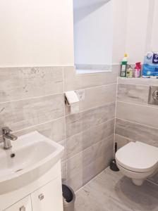 a bathroom with a white toilet and a sink at Maison de l'aire in Fraissinet-de-Fourques +13 photos