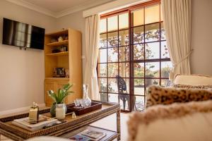 a living room with a table and a large window at 'Videre' in Rylstone