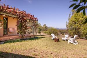 a group of white chairs sitting on a yard at 'Videre' in Rylstone
