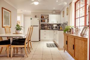 a kitchen with a table and a white refrigerator at 'Videre' in Rylstone