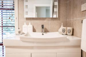 a bathroom with a white sink and a mirror at 'Videre' in Rylstone +75 photos