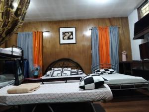 a bedroom with two beds in a room at Jenny's transient house in Baguio