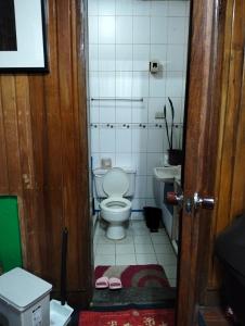 a small bathroom with a toilet and a sink at Jenny's transient house in Baguio +10 photos