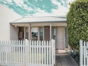 a white picket fence in front of a house at Bella Casa in Queenscliff