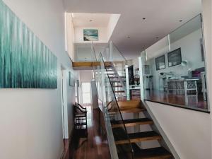 a staircase in a house with a glass wall at Bella Casa in Queenscliff