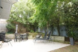 a group of chairs and tables in a patio at Dinghy s Rest in Queenscliff