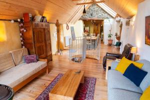 a living room with a couch and a table at Ecogîte nature de bieisses in Quézac +35 photos
