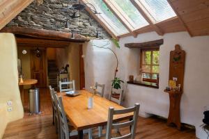 a dining room with a wooden table and chairs at Ecogîte nature de bieisses in Quézac