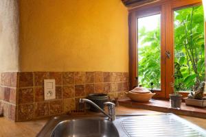 a kitchen with a sink and a window at Ecogîte nature de bieisses in Quézac