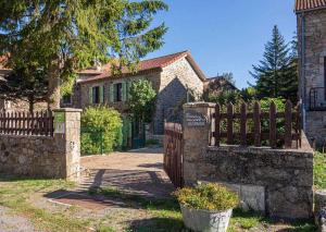 a wooden fence in front of a house at La maison d'anna in Langogne