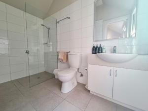 a bathroom with a toilet and a sink and a shower at Doongarra in Queenscliff