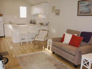 a living room with a couch and a kitchen at Doongarra in Queenscliff