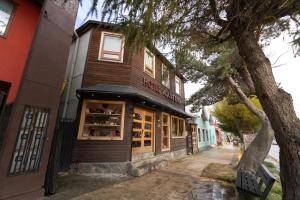 a building with a store on a street at Hotel Aquaterra in Puerto Natales