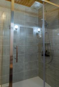a bathroom with a shower with a glass door at La maison d'anna in Langogne +37 photos