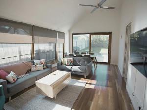 a living room with a couch and a coffee table at Galway Cottage in Queenscliff