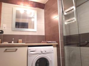 a bathroom with a washing machine and a sink at La drosera in Lajo +12 photos