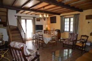 a living room with a table and chairs at La parrot en margeride in Pierrefiche