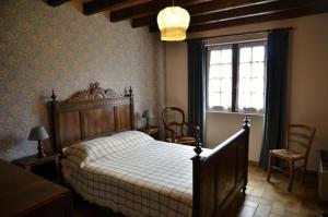 a bedroom with a large bed and a window at La parrot en margeride in Pierrefiche