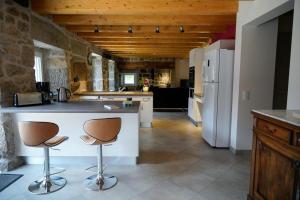 a kitchen with a white refrigerator and a counter at La maison de clémence 6 personnes in Mialanes