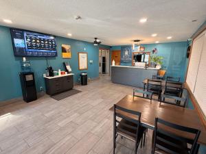 a restaurant with a table and chairs and a bar at Best Nights Hotel in Fond du Lac