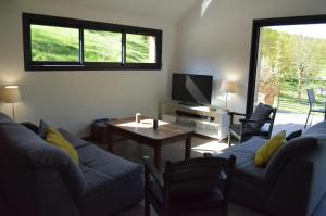 a living room with a couch and a table at Gîte les falaises à barjac in Barjac