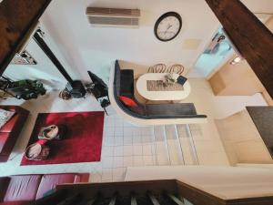 a room with a table and a clock on the wall at Intermission in Queenscliff +4 photos