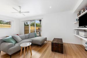 a living room with a couch and a table at Lochaber in Point Lonsdale +6 photos