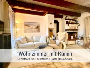 a living room with a couch and two chairs at Reetdachhaus in Seenähe, Ruhige Lage, Kamin & Terrasse in Seedorf