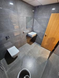 a bathroom with a toilet and a sink at hotel vistara luxe in Himatnagar +15 photos