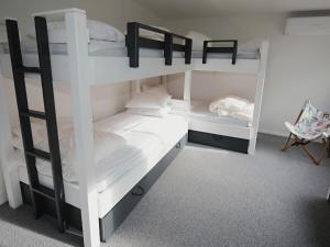 a bedroom with two bunk beds and a chair at Lonsdale on Glaneuse in Point Lonsdale