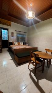 a bedroom with a bed and a table in it at Kubumade in Sanur
