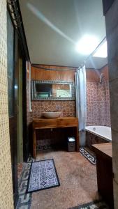 a bathroom with a sink and a mirror and a tub at Kubumade in Sanur +51 photos