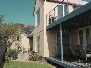 a porch of a house with chairs and a table at Lonsdale Shores in Point Lonsdale