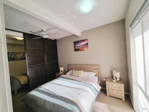 a bedroom with a bed and a window at Marley s Place in Queenscliff