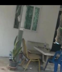 a table and two chairs with a laptop on it at 50 m by BTS Taladplu in Thonhuri +7 photos