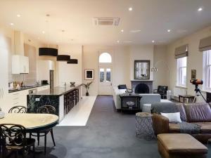 a living room and kitchen with a couch and a table at Penthouse Ozone in Queenscliff