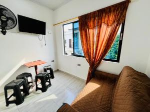 a living room with a couch and a window at Apartahotel Dazuwi in Doradal