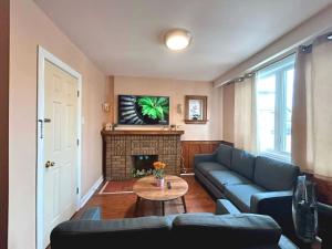 a living room with a couch and a fireplace at TORONTO Midtown HomeHaven in Toronto
