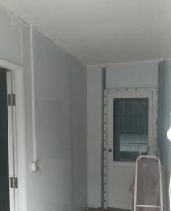 a white door with a window in a room at 50 m by BTS Taladplu in Thonhuri
